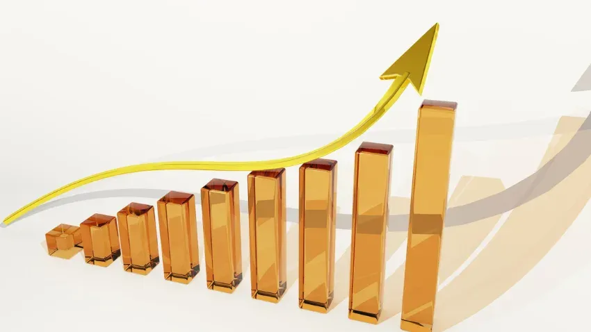 A rising bar chart in amber glass with a gold arrow curving up over the tallest bar.